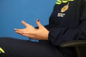 Imagem colorida de mãos de mulher com farda da PMDF