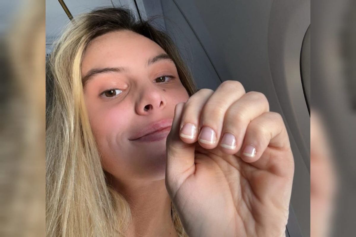 Foto mostra a influenciadora Lele Pons em segundo plano, mostrando suas unhas para a câmera