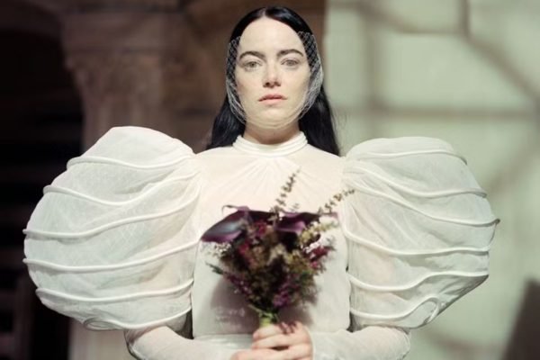 Na imagem com cor, Bella Bexter, de Pobres criaturas, com um vestido de noiva - Metrópoles
