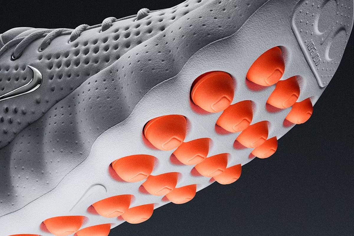 Imagem colorida de tênis cinza com bolas laranjas